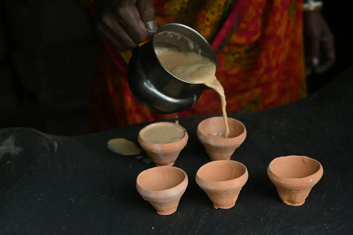Chai being poured into small clay cups