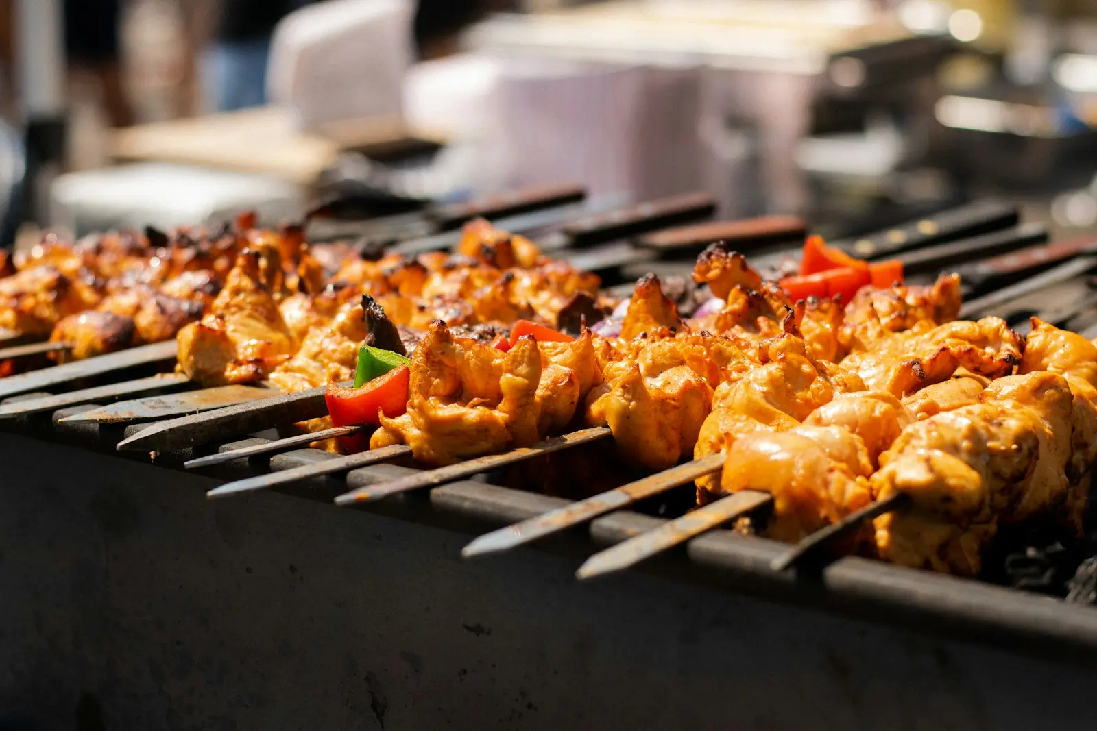 Skewers of chicken and vegetables over glowing coals